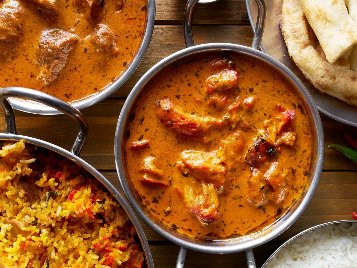 Indian curry, rice and accompaniments served together for the buffet